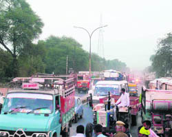  Irate farmers block the Delhi-Sirsa National Highway at Fatehabad on Friday.