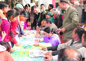 Employees of the H.P. State Electricity Board completing formalities prior to distribution of CFL bulbs at Mahadev village, near Sundernagar