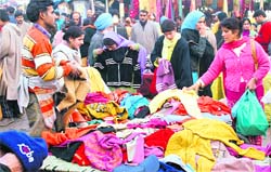Women buy clothes ahead of Eid-uj- Zuha at Lal Chowk in Srinagar