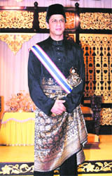 SRK in a traditional official black Malay costume and songkok cap poses after he received the title of Datuk in Malacca on Saturday.