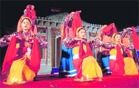 Women perform mangal geet at the Khadi festival in Dehradun