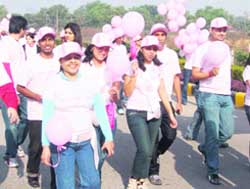 People take part in a walk to create awareness about breast cancer in Gurgaon on Sunday. 