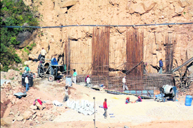 Ordinary concrete mixing machines being used for the construction of Bathu bridge on the Kangra-Ranital stretch of the national highway.
