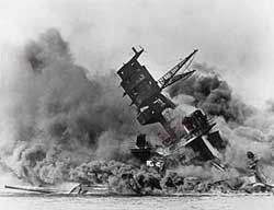 In this December 7, 1941, file photo, the battleship USS Arizona belches smoke as it topples over into the sea during a Japanese surprise attack on Pearl Harbor. 