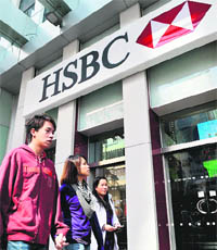 People walk past a HSBC branch in Hong Kong on Monday.