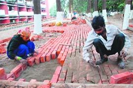 The ongoing work on the parking lot of the boys Hostel No 4, Panjab University, Chandigarh, on Monday. 