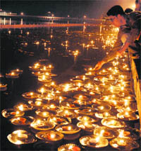 A man lights earthen lamps to mark the Gita Jayanti Samaroh at the Brahmsarovar in Kurukshetra on Monday.