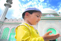 A child prays on the eve of Id-ul-Azha in Jammu.