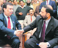 Oututgoing VC Amitabh Matto (left) welcomes new VC Varun Sahni on the university campus in Jammu on Monday. 