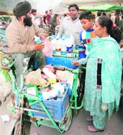 Differently abled Raju loads his tricycle with consumer products to sell them across the city.
