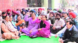 Members of the Sanchar Nigam Executive Association stage a dharna outside the office general manager in Ludhiana on Monday.