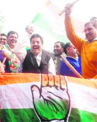 Congress workers celebrate the victory of their party in Delhi, Rajasthan and Mizoram in New Delhi