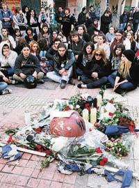 Students pay tribute at the site where 15-year-old Alexandros Grigoropoulos was shot dead by the police in Athens