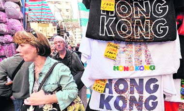 Tourists look for bargains at a street market in Hong Kong