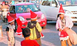 Children sell Christmas caps in Chandigarh