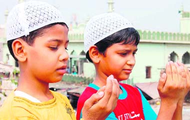 Two children offer Id prayers at a masjid on the NH-8 in Gurgaon