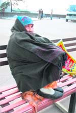 A woman cover herself as the temperature falls in Shimla