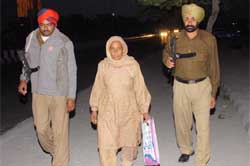 Baljeet Kaur flanked by her security guards