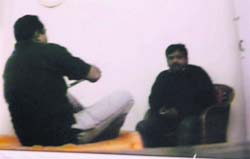 A video grab showing NCB investigating officer, Ravi Kant Pawar, talking to Ajay Malik, who conducted the sting operation