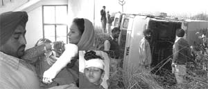 An injured student (inset) at Civil Hospital in Rajpura; and (right) the school bus that overturned. A Tribune photograph