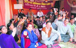Parent-Teacher Assocation members stage a dharna at the Vidhan Sabha in Dehradun