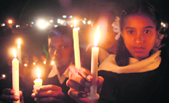 Students participate in a candlelight march against terrorism in Jammu on Wednesday.