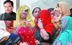 The grieving family of Pradeep Tyagi (inset) at Ghaziabad