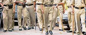 Policemen stand guard at a complex believed to be housing the lone surviving gunman Mohammed Ajmal Kasab from the attacks in Mumbai.