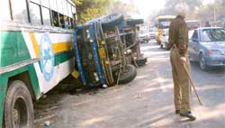 A mini-truck that overturned after it collided with a PRTC bus on the busy Bathinda-Barnala road