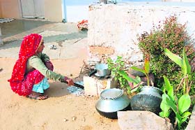 CPI-M candidate Pema Rams wife sweeping the floor in front of their hut