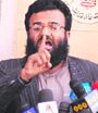 Atiq ur Rahman, spokesman of Jamaat-ud-Dawa, speaks in front of his sealed office in Peshawar on Friday.
