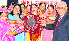 H.K. Dua, Editor-in-Chief, The Tribune, gives away prizes to the winners of dance competition at the founders day celebration of the Baba Mehar Charitable Trust at Bassi Pathana on Sunday.
