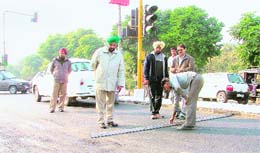 Municipal commissioner G.S. Ghuman inspects recarpeting work on the Ferozepore Road in Ludhiana on Sunday. 