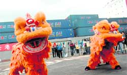 A lion dance is seen at a ceremony in the northern Keelung port