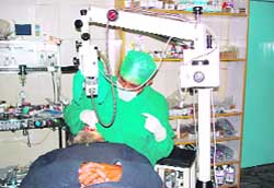 Dr Avnish Gupta performs an eye operation in Sirsa on Monday with the help of a microscope developed by the CSIO