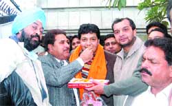O.P. Soni, MLA, offers sweets to Dinesh Bassi on his victory in the election to the president of the district Youth Congress (U) in Amritsar 