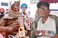 (Left) Ramli, widow of sepoy Banwari Lal, who was conferred the Vir Chakra posthumously, shows the medal; Jaga Ram (right), an ex-serviceman, shows off his medals during the Vijay Diwas celebrations at Bathinda cantonment