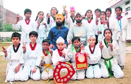 The winning team of the Punjab State Taekwondo Championship in Patiala on Tuesday. A Tribune photograph