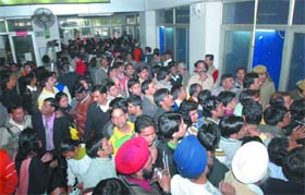 People gather outside the DDA office in New Delhi