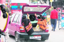 Commuters packed inside a car in Dehradun
