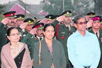 Dhanalakshmi (centre) and K.Unnikrishnan (in blue shirt), mother and father of Major Sandeep Unnikrishnan, pay homage to the martyrs at the War Memorial in IMA on Tuesday. 