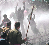 Teachers face water cannons and lathis near the Vidhan Sabha in Dehradun on Tuesday.