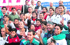 Gurukul University players pose with the winners trophy in Haridwar on Tuesday.