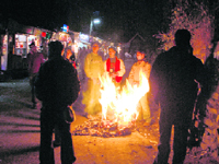 People light a bonfire to warm themselves up at Shimla on Tuesday.