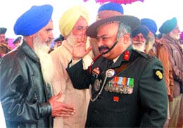 Brig V. Narayanan greets an ex-serviceman on Vijay Divas at Khasa in Amritsar