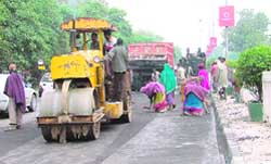 A portion of the GT Road being recarpeted even after rain in