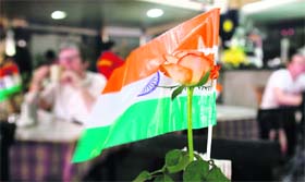 The national flag and a rose are seen on a table at the Cafe Leopold, one of the sites hit by gunmen in last month's attack on Mumbai