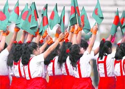 Students wave the national flag during a Victory Day parade celebrating Bangladesh's independence in Dhaka. Bangladesh celebrated its 37th Victory Day