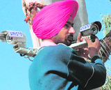 A worker installs a CCTV camera outside the Taj Hotel in Sector 17, Chandigarh, on Wednesday.