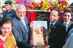 Chief Minister Bhupinder Singh Hooda presents an idol of Ganesha to President of Mauritius Anerood Jugnauth during his visit to Holi village, near Ambala